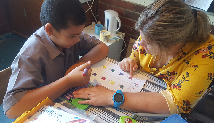 Rachelle supporting a student in the classroom