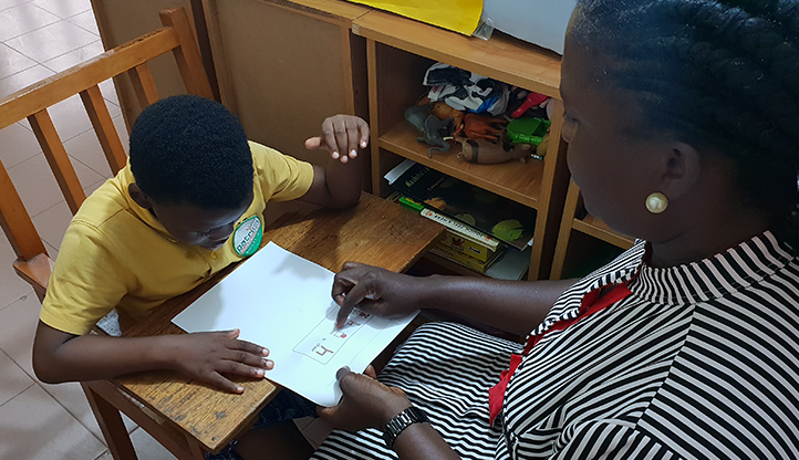 Symbol materials being used to support a child at the Winford Centre